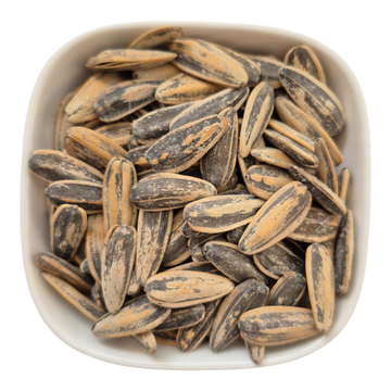 Close-up of Nut Fusion jumbo sunflower seeds in a bowl, showcasing large, healthy sunflower seeds for snacking and planting.