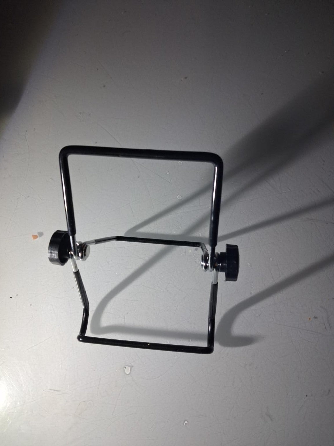 Black adjustable sprouting jar stand shown open.
